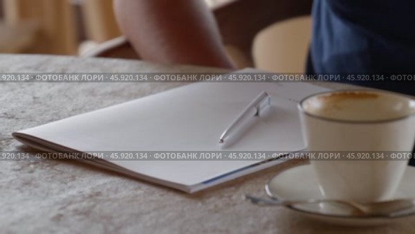 A Creative Workspace Complete with Coffee and a Notebook for Inspiration and Comfort. Стоковое видео, видеограф PAv / Фотобанк Лори