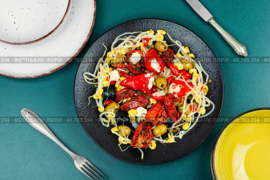 A delicious salad of pickled soybean sprouts, dried tomatoes, olives and peppers. Chinese food.. Vegan Salad of Pickled Vegetables and Soybeans. Стоковое фото, агентство Ingram Publishing / Фотобанк Лори