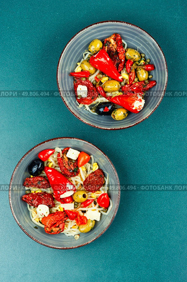 A delicious salad of pickled soybean sprouts, dried tomatoes, olives and peppers. Chinese food.. Vegan Salad of Pickled Vegetables and Soybeans. Стоковое фото, агентство Ingram Publishing / Фотобанк Лори