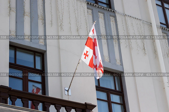 A flag of Georgia with red, white, and blue colors and a cross design on it. Стоковое фото, фотограф Аксенова Вера / Фотобанк Лори