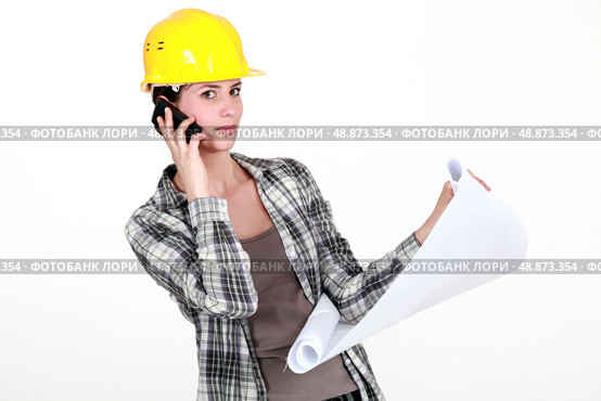 A foreman on the phone going over the plans. Стоковое фото, агентство Ingram Publishing / Фотобанк Лори