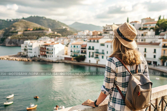 A girl traveler with a backpack on the background of the southern coast of the sea. A woman travels, enjoys life and the environment. Tourism. Стоковое AI-изображение, AI-художник Photojuli / Фотобанк Лори
