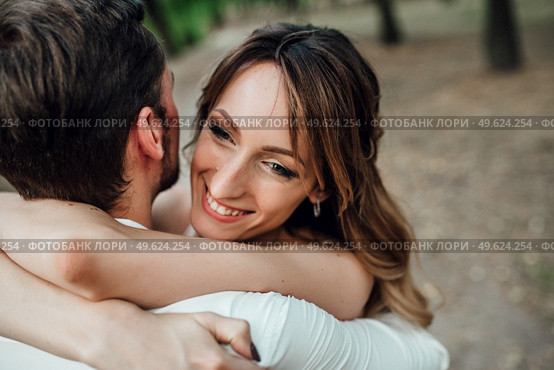 a guy and a girl are walking along the banks of a wild river overgrown with willows and forest. Стоковое фото, агентство Ingram Publishing / Фотобанк Лори