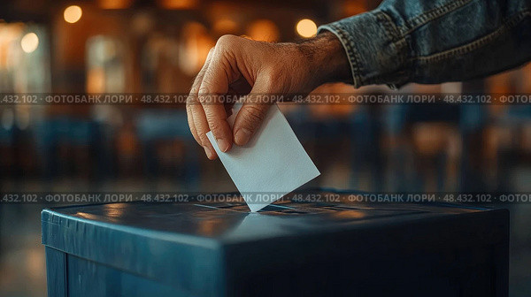 A hand drops a ballot into a voting box, emphasizing the importance of citizen participation in the electoral process during elections. Стоковое AI-изображение, AI-художник Данила Большаков / Фотобанк Лори