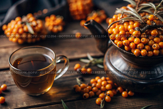 A healthy, ripe sea buckthorn berry in close-up. Vitamin, orange, autumn, seasonal tea made from sea buckthorn berries on a dark background. Berry tea for the immune system. Стоковое AI-изображение, AI-художник Photojuli / Фотобанк Лори