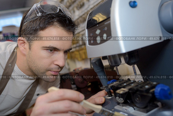 a man fixing a machine. Стоковое фото, агентство Ingram Publishing / Фотобанк Лори