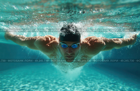 A man is swimming in a pool wearing goggles. Стоковое AI-изображение, AI-художник Ярославский Максим / Фотобанк Лори