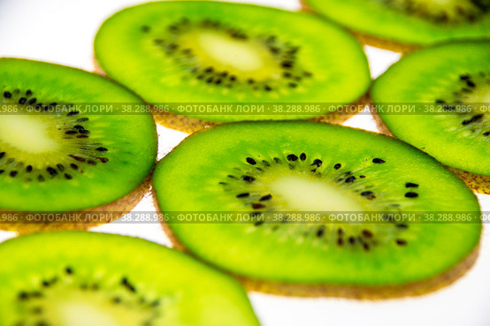 A pattern of fresh kiwi slices on a white background. Стоковое фото, фотограф Ярославский Максим / Фотобанк Лори