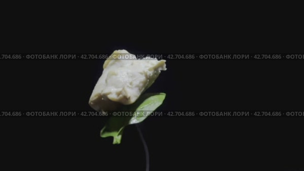 A piece of boiled chicken and a leaf of ripe greens rotate on a fork on a dark background. Exquisite cuisine. Close-up shooting. Стоковое видео, видеограф Ярославский Максим / Фотобанк Лори