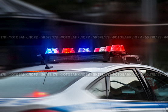 A police car rushes to the emergency call with lights turned on. Стоковое фото, агентство Ingram Publishing / Фотобанк Лори