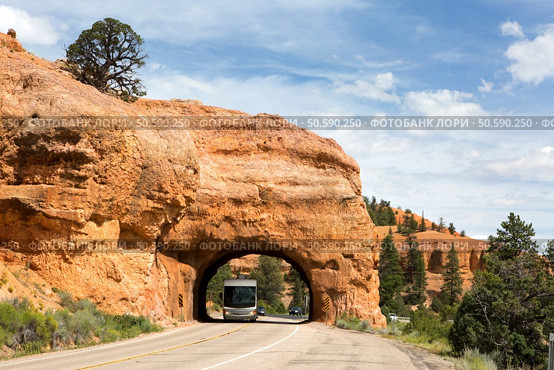 A recreational vehicle RV travels through a tunnel in Red Canyon in Dixie National Forest, Utah. Стоковое фото, агентство Ingram Publishing / Фотобанк Лори