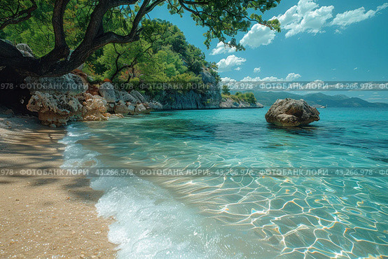A secluded tropical cove with crystal clear waters lapping golden sandy shores. In the foreground you can see the shadow of a large tree, spreading its branches over the water, creating coolness and shade. The shore is surrounded by rocks and green trees, which gives the place natural beauty and wildness. The water is clear, with shimmers of light, and pitfalls are visible. The sky is clear with occasional clouds adding depth and tranquility to the scene. Стоковое AI-изображение, AI-художник Анна Кривицкая / Фотобанк Лори