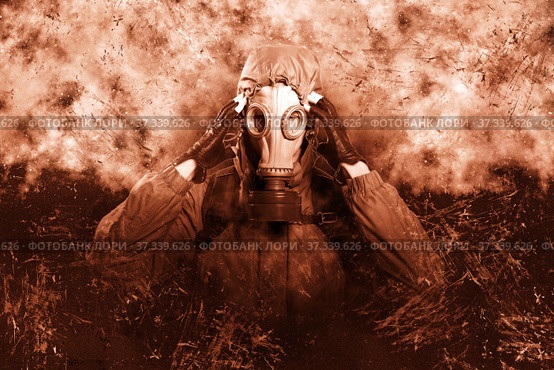 A shot of a man dressed in a gas mask, a jacket with a hood, a backpack, holding his fingers at the temple, a headache. A poster on the background of grunge. Стоковое фото, фотограф Владимир Арсентьев / Фотобанк Лори