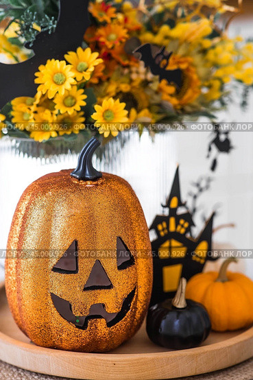 A vase of flowers, pumpkins and a scary castle with a witch on the background of a Scandi-style white kitchen interior. The concept of home and comfort. Autumn decor for Halloween. Стоковое фото, фотограф Photojuli / Фотобанк Лори