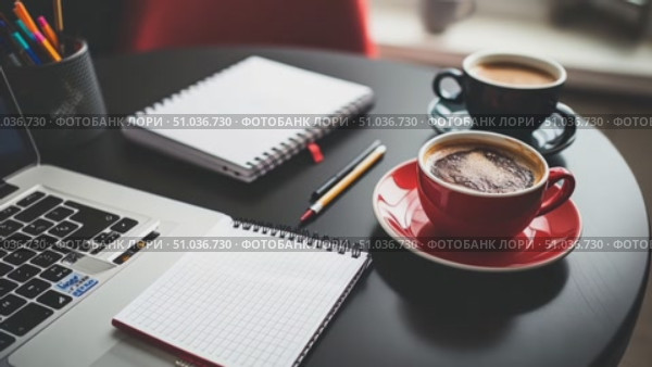 A warm, inviting workspace with two coffee cups, a laptop, and a notebook on a table, ideal for focusing and generating ideas. Стоковое AI-видео, аниматор Данила Большаков / Фотобанк Лори
