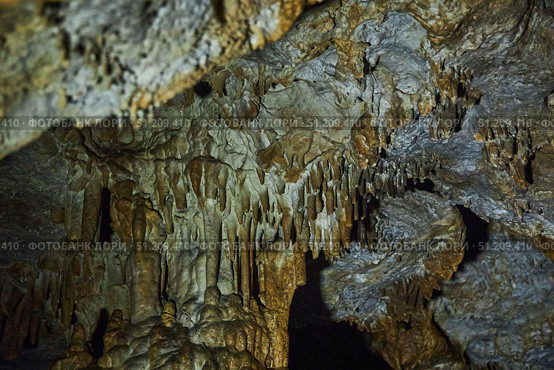 A wild cave inside. Stalactites and stalagmites. Speleology and surveys. Стоковое фото, фотограф Наталия Кирсанова / Фотобанк Лори