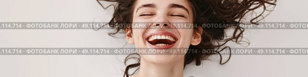 A woman is lying down on her back, laughing heartily. She is relaxed and joyful in the moment. Стоковое AI-изображение, AI-художник Данила Большаков / Фотобанк Лори