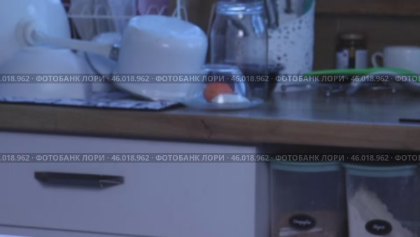 A woman is reviewing a knitted set. A knitted sweater and skirt. She is laying out the clothes on the table. Close-up. Стоковое видео, видеограф Vadzim Yakubovich / Фотобанк Лори