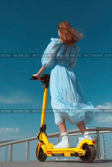 A woman is riding a yellow scooter. Стоковое AI-изображение, AI-художник Ярославский Максим / Фотобанк Лори
