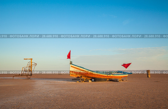 A wooden boat at the large salt lake Chott El Jerid, Tunisia. Morning time. October. Стоковое фото, фотограф Сергей Цепек / Фотобанк Лори