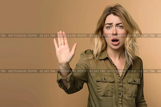 A young lady in a green shirt puts her hand in front of her in fright, asks her to stop and looks at the camera. Стоковое AI-изображение, AI-художник Ярославский Максим / Фотобанк Лори