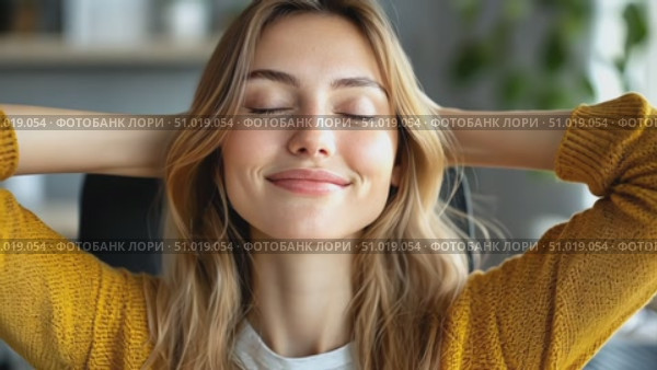 A young woman smiles contentedly while resting her hands behind her head, savoring a tranquil moment in her inviting home office space. Стоковое AI-видео, аниматор Данила Большаков / Фотобанк Лори