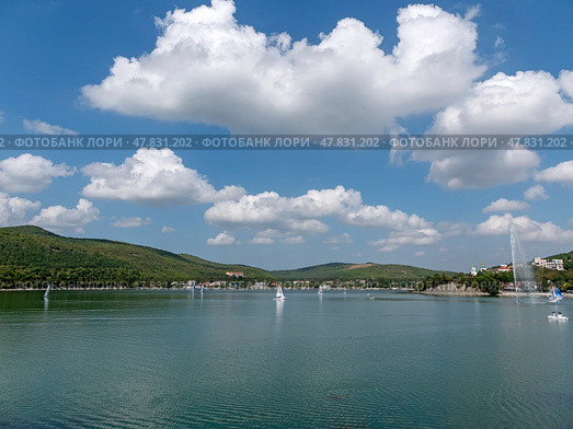 Abrau Durso, Russia 28 August 2024: Panoramic view of the lake Abrau-Durso with sailboats on a sunny day. Стоковое фото, фотограф Фотограф / Фотобанк Лори