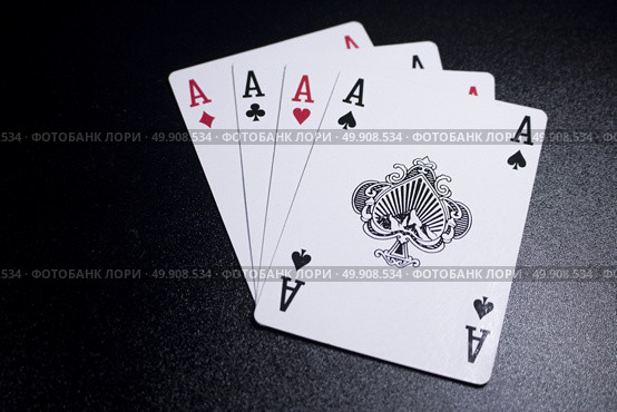 ace four of a kind poker card on dark black background. Стоковое фото, агентство Ingram Publishing / Фотобанк Лори
