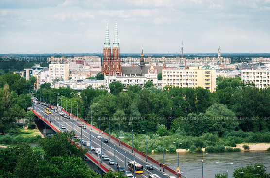 Aerial view of cityscape of Warsaw, Slasko-Dabrowski bridge over the the Vistula river on the foreground and Cathedral of St. Michael the Archangel and St. Florian the Martyr among the buildings of Praga district on the background. Poland. Стоковое фото, фотограф Andrei Bortnikau / Фотобанк Лори