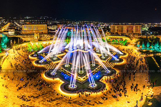 Aerial view to largest light and music fountain in Russia. 2214 colours jets burst into sky with musical accompaniment. Night show "fire on the water" in Nizami Ganjavi Park Derbent, Dagestan, Europe. Стоковое фото, фотограф Алексей Ширманов / Фотобанк Лори