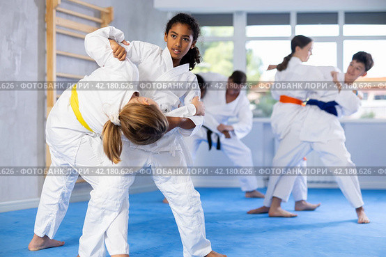 African american teenage girl practicing martial arts fighting techniques in sparring. Стоковое фото, фотограф Яков Филимонов / Фотобанк Лори