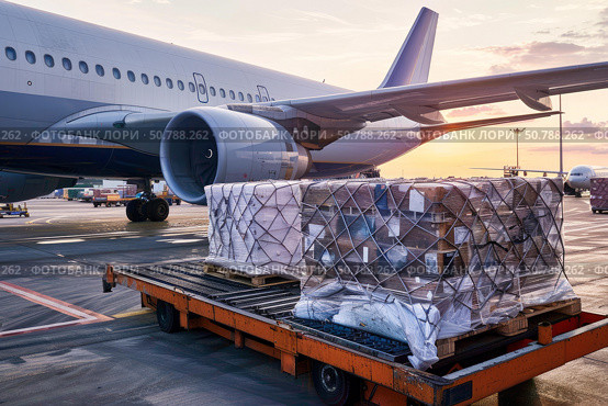 Air cargo waiting for loading to airplane at sunset. Стоковое AI-изображение, AI-художник Иван Рябоконь / Фотобанк Лори