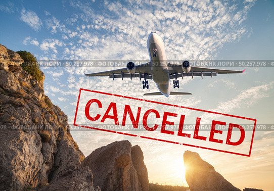 Airplane and flight cancellation. Canceled flights in Europe, Asia and USA airports. Travel cancelled. Pandemic of coronavirus. Fying passenger aircraft over the mountains at sunset and text. Covid-19. Стоковое фото, агентство Ingram Publishing / Фотобанк Лори