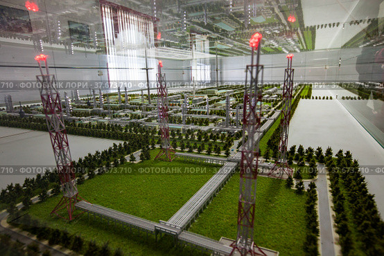 Aktobe region/Kazakhstan - May 04 2012: Scale miniature (maquette) of modern oil refinery and gas processing plant. Gas torch masts with burning gas. Редакционное фото, фотограф Alexey Rezvykh / Фотобанк Лори