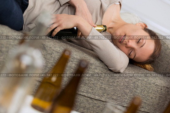 alcoholic woman sleeping holding the bottles. Стоковое фото, агентство Ingram Publishing / Фотобанк Лори