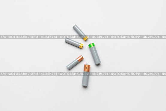 Alkaline batteries on white background, top view. Стоковое фото, фотограф Pixel_shot / Фотобанк Лори