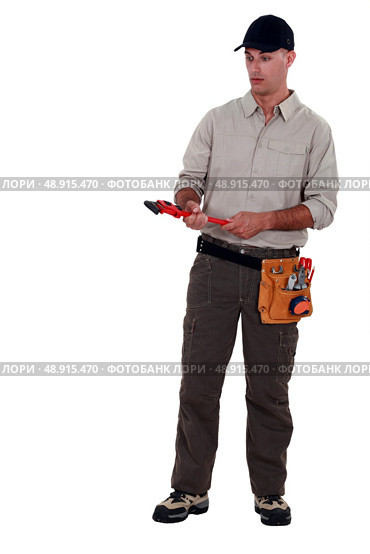 Amazed man holding a pipe wrench. Стоковое фото, агентство Ingram Publishing / Фотобанк Лори