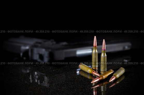 Ammunition cartridges on black background. Ammunition cartridges on black. Стоковое фото, агентство Ingram Publishing / Фотобанк Лори