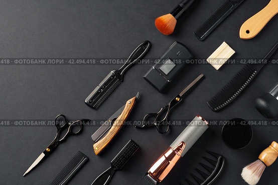 An Assortment of Professional Hairdressing Tools Laid Out on a Dark Surface. Стоковое фото, фотограф Сергей Толмачёв / Фотобанк Лори