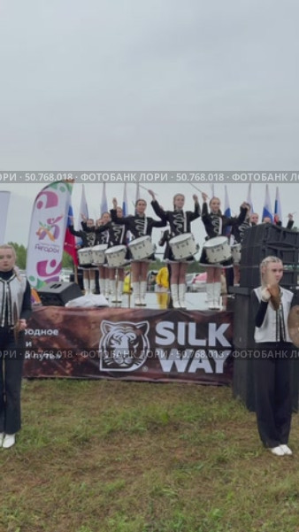 ANGARSK, IRKUTSK REGION, RUSSIA - July 13, 2025: XV International Silk Way Rally, racing competition.Vertical video of group of beautiful drummers girls perform on open stage before start of motor rally. Редакционное видео, видеограф Виктория Катьянова / Фотобанк Лори