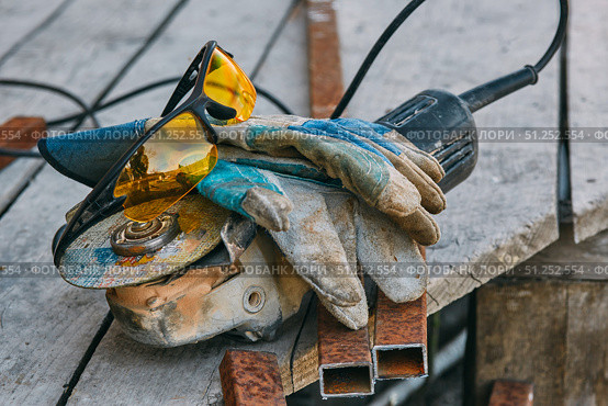 Angle grinder, safety goggles, gloves, a piece of pipe. Worker tools. Стоковое фото, фотограф Арзюков Вадим Николаевич / Фотобанк Лори