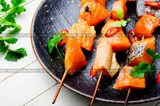 Appetizing pieces of dried salted salmon on skewers.Salty red fish. Dried fish salmon. Стоковое фото, агентство Ingram Publishing / Фотобанк Лори