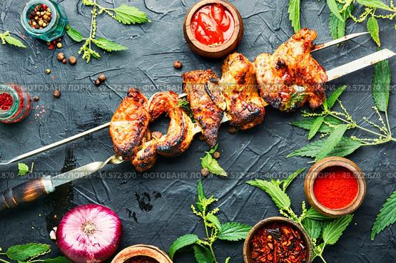 Appetizing shashlik on skewers with nettle marinade.. Kebabs,grilled meat with nettles. Стоковое фото, агентство Ingram Publishing / Фотобанк Лори