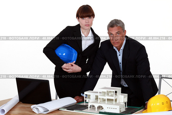 Architect and colleagues preparing business proposal. Стоковое фото, агентство Ingram Publishing / Фотобанк Лори