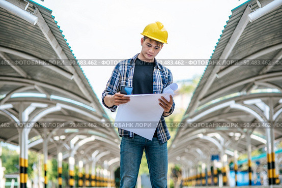 Architects hold the building plan and check the work. Стоковое фото, агентство Ingram Publishing / Фотобанк Лори