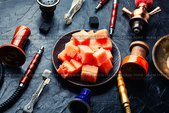 Aromatic smoking hookah with watermelon flavored tobacco. Mouthpiece for smoking hookah. Стоковое фото, агентство Ingram Publishing / Фотобанк Лори