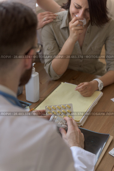 At doctor office. Doctor talking to crying patient after tests. Closeup portrait. Стоковое фото, агентство Ingram Publishing / Фотобанк Лори