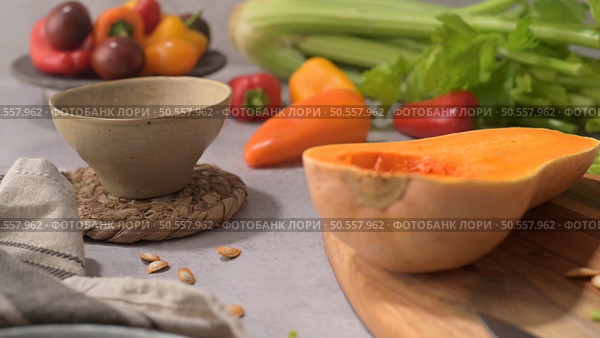Autumn vegetables arranged on a kitchen worktop while preparing a pumpkin soup. Стоковое фото, агентство Ingram Publishing / Фотобанк Лори