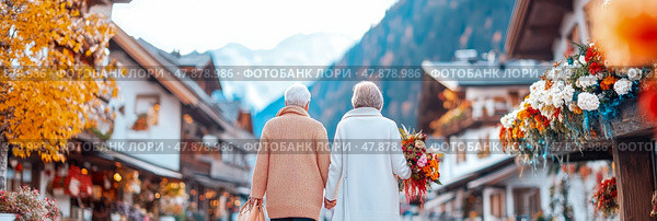 Autumnal amble: elderly companionship in a blooming Alpine town, a moment of togetherness with mountain backdrop, memories made and love shared. Стоковое AI-изображение, AI-художник Данила Большаков / Фотобанк Лори