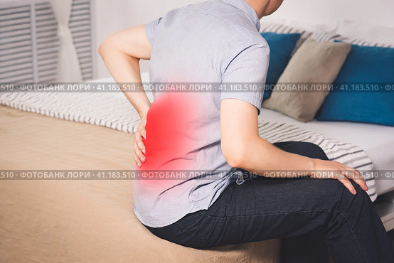 Back pain, kidney inflammation, man suffering from backache at home. Стоковое фото, фотограф Станислав Тарко / Фотобанк Лори